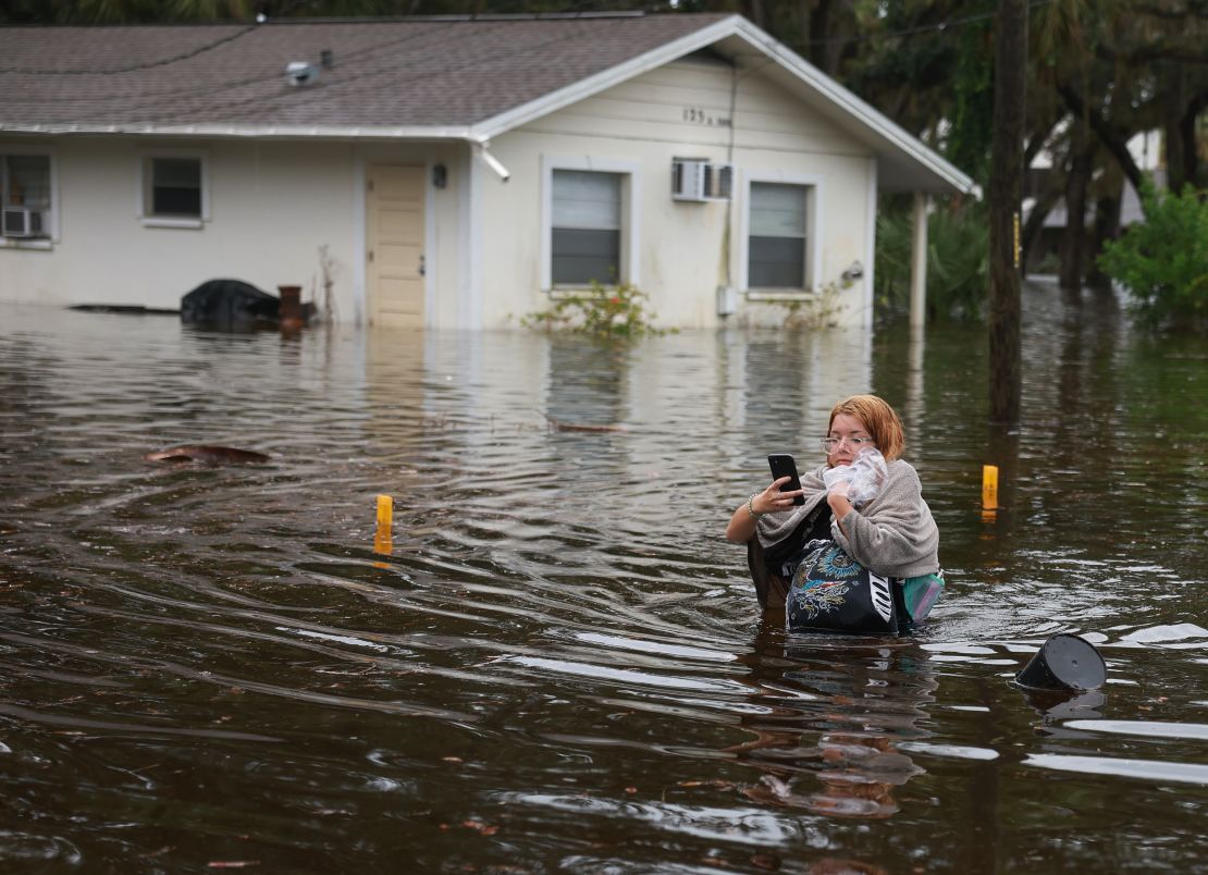 TARPON SPRINGS, FLORIDA - AUGUST 30: Makatla Ritchter wades through flood waters after having to evacuate her home when the flood waters from Hurricane Idalia inundated it on August 30, 2023 in Tarpon Springs, Florida. Hurricane Idalia is hitting the Big Bend area of Florida. (Photo by Joe Raedle/Getty Images)