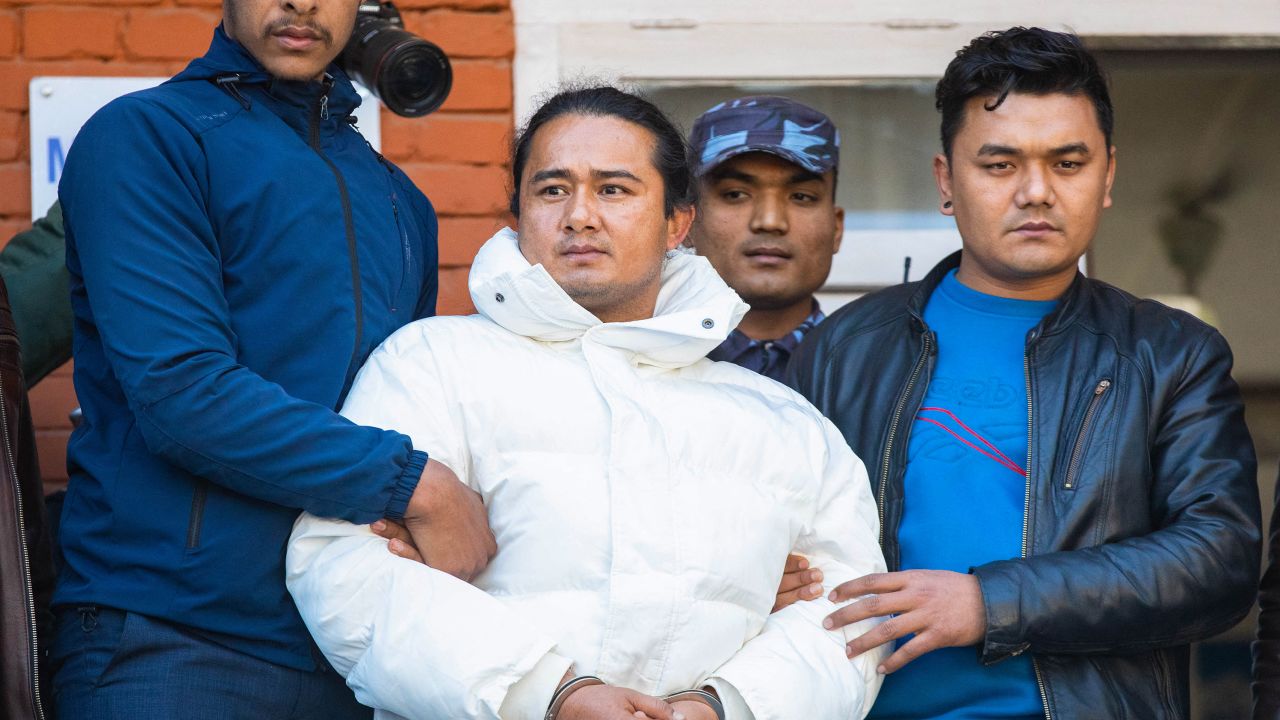 Nepal police escort Ram Bahadur Bomjam (C), a spiritual leader whose devotees believe him to be a reincarnation of Buddha, at the premises of Nepal's Central Investigation Bureau in Kathmandu on January 10, 2024. Nepal police said on January 10 they had arrested a spiritual leader whose devotees believe him to be a reincarnation of Buddha over allegations of disappearances and rape at his ashrams. (Photo by PRABIN RANABHAT / AFP) (Photo by PRABIN RANABHAT/AFP via Getty Images)