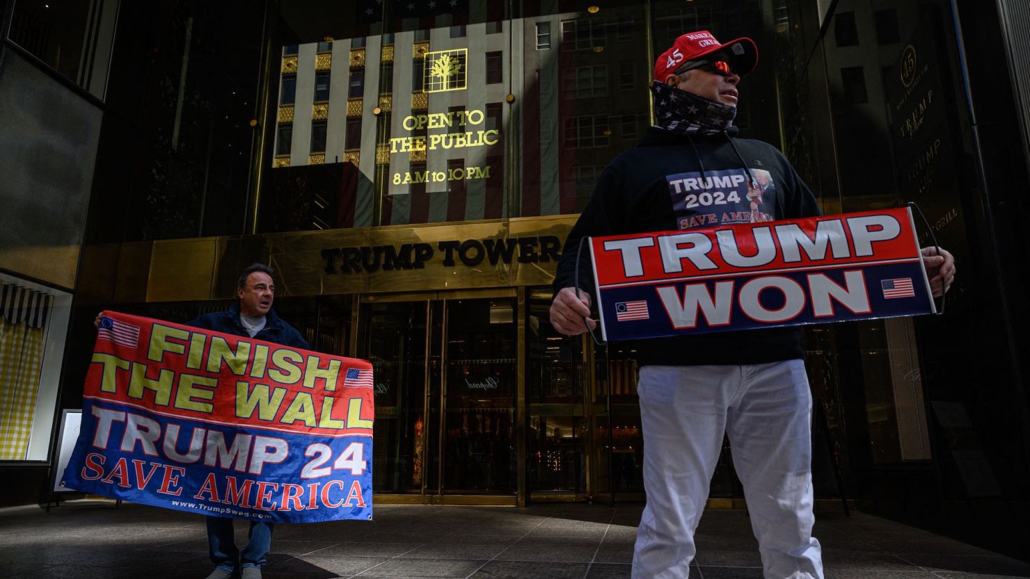 TOPSHOT - Supporters of former US President Donald Trump gather outside Trump tower in New York City on March 20, 2023. - Former US President Donald Trump said he expects to be "arrested" on Tuesday, March 21, 2023, over an alleged hush-money payment to a porn star in 2016 and he urged his supporters to protest, as prosecutors gave signs of moving closer to an indictment. (Photo by Ed JONES / AFP) (Photo by ED JONES/AFP via Getty Images)