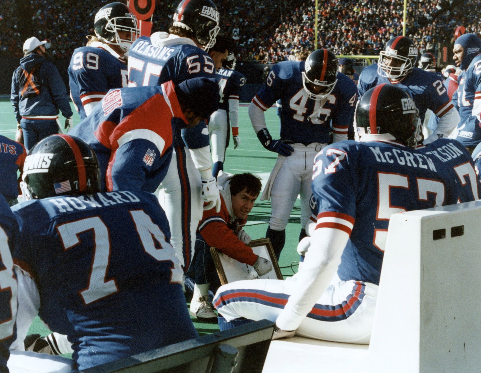 Belichick diagrams his strategy as he talks to his players during a playoff game in 1990.