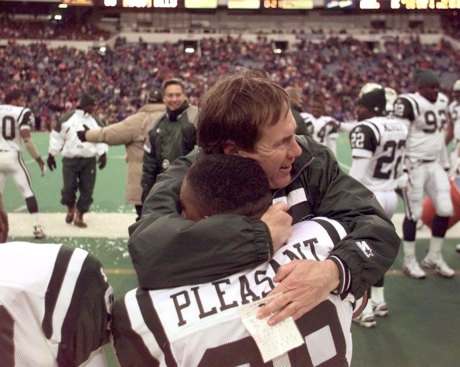 Belichick hugs Anthony Pleasant after defeating the Buffalo Bills in 1998. He was serving under Parcells again as the New York Jets' defensive coordinator.