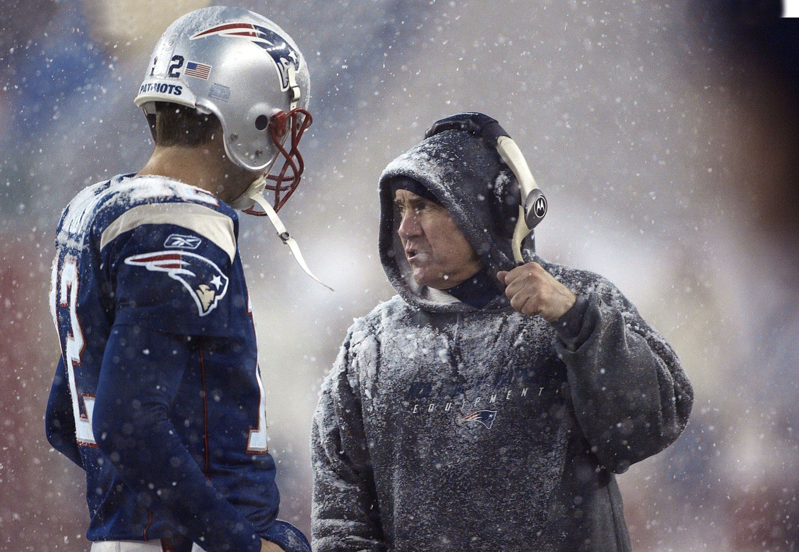 Quarterback Tom Brady listens to Belichick during a snowy game against the Jacksonville Jaguars in 2003. The two helped transform the Patriots into a 21st-century juggernaut.