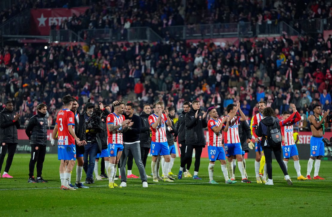 Girona's Spanish coach Michel (C,L) and team members celebrate victory at the end of the Spanish league football match between Girona FC and Club Atletico de Madrid  at the Montilivi stadium in Girona on January 3, 2024. Girona won 4-3. (Photo by Pau BARRENA / AFP) (Photo by PAU BARRENA/AFP via Getty Images)