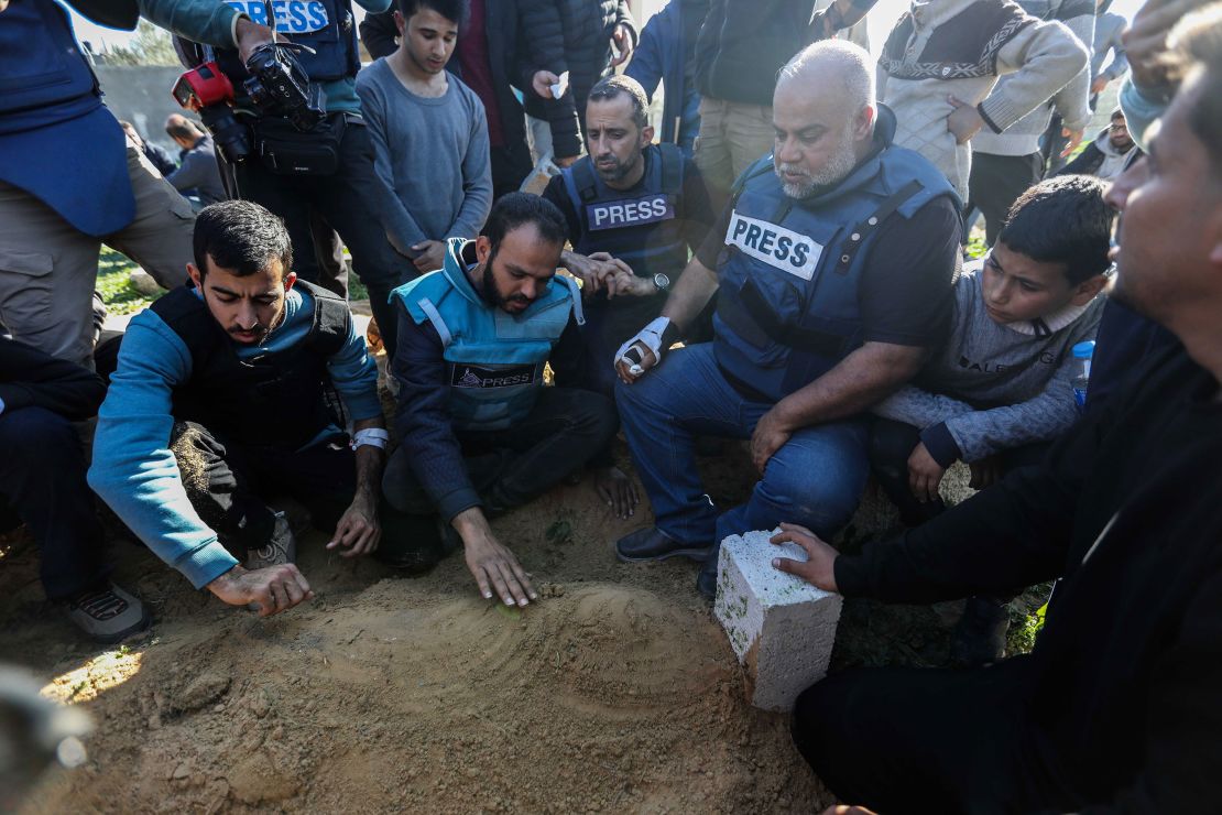 RAFAH, GAZA - JANUARY 7: Family and friends including Al Jazeera reporter, Wael Al-Dahdouh (3rd R), bid farewell to the bodies of journalists Hamza Al-Dahdouh and Mustafa Thuraya on January 7, 2024 in Rafah, Gaza. The journalists, Hamza Al-Dahdouh and Mustafa Thuraya, were reportedly killed when their car was bombed after reporting from an air strike on a building this morning. Hamza is the son of Al Jazeera reporter Wael Al-Dahdouh, whose wife, daughter, grandson and another son were killed in an Israeli air strike earlier in the war. (Photo by Ahmad Hasaballah/Getty Images)