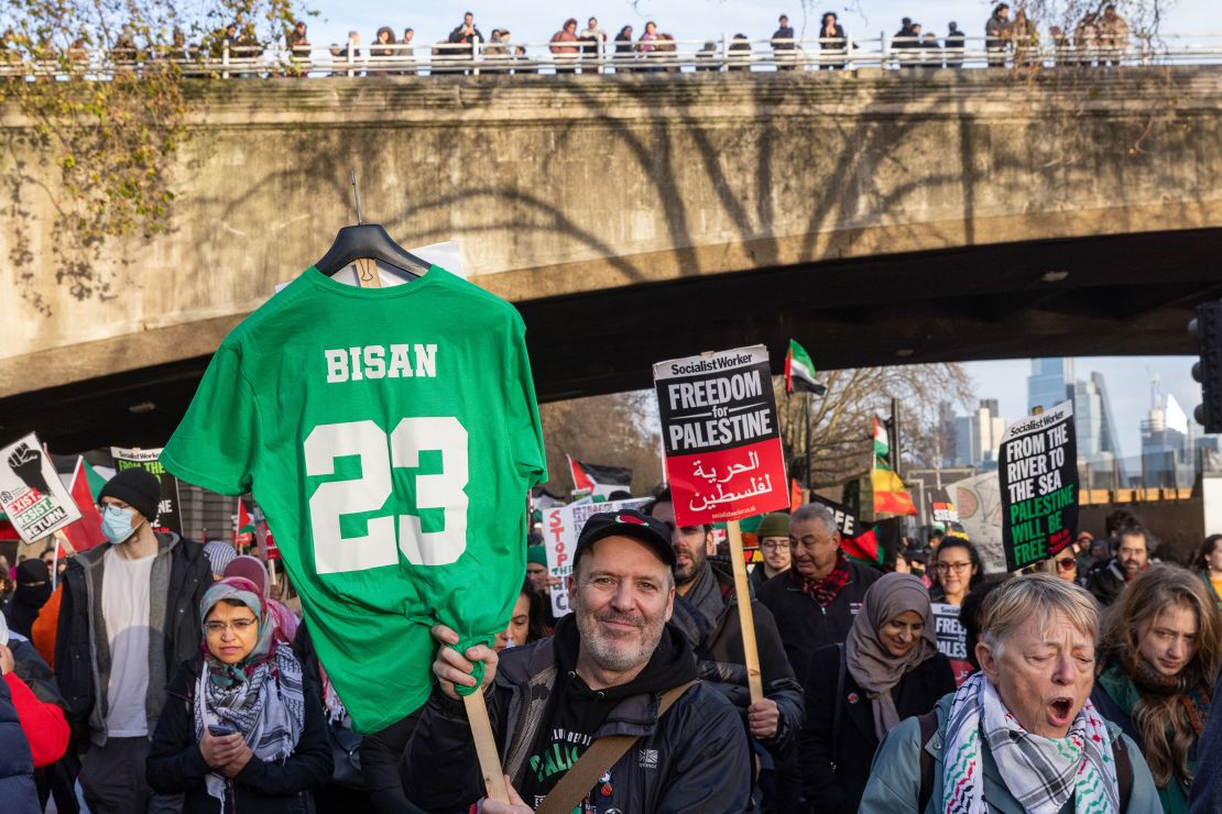 A pro-Palestinian activist holds a shirt paying tribute to young Palestinian filmmaker Bisan Owda during a National March for Palestine to call for a permanent ceasefire in Gaza on 9th December 2023 in London, United Kingdom. The march, from the City of London to Westminster, was organised by Palestine Solidarity Campaign, Stop the War Coalition, Friends of Al-Aqsa, Muslim Association of Britain, Palestinian Forum in Britain and CND. (photo by Mark Kerrison/In Pictures via Getty Images)