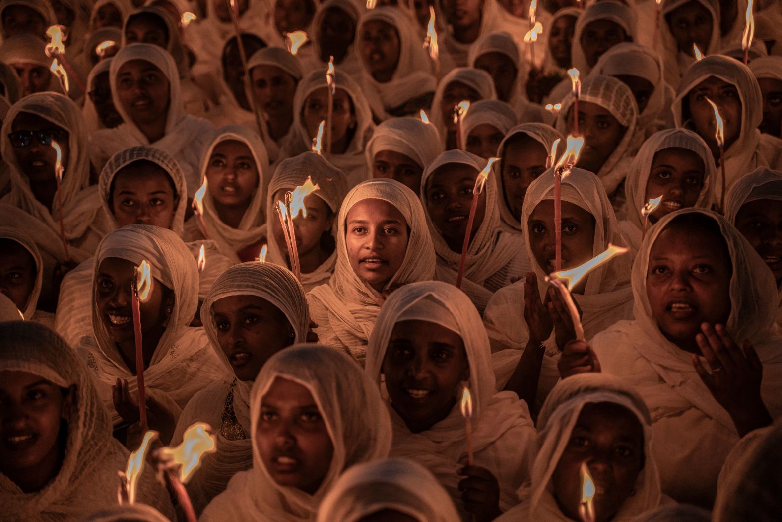 Ethiopian Orthodox worshippers hold candles as they gather to pray ahead of Ethiopian Orthodox Christmas celebrations at the Bole Medhanialem Church in Addis Ababa on Saturday, January 6.