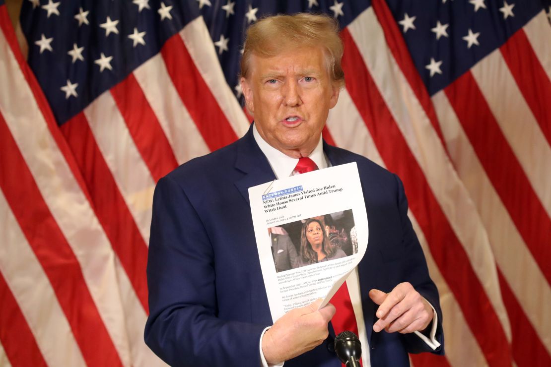 NEW YORK, NEW YORK - JANUARY 11: Former U.S. President Donald Trump holds up a news story about New York Attorney General Letitia James as he speaks to the media at one of his properties at 40 Wall Street following closing arguments at his civil fraud trial on January 11, 2024 in New York City. 