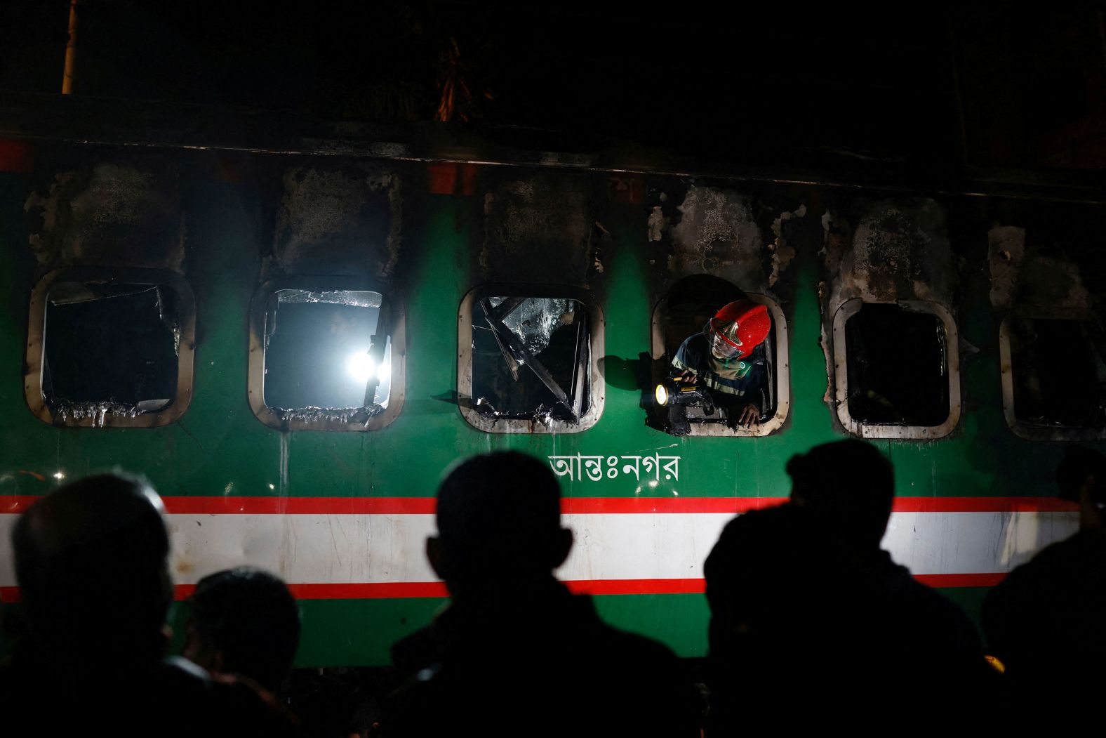 A firefighter looks through the window of a passenger train that was on fire in Dhaka, Bangladesh, on Friday, January 5. According to the Reuters news agency, <a href="index.php?page=&url=https%3A%2F%2Fwww.reuters.com%2Fworld%2Fasia-pacific%2Fleast-4-dead-suspected-train-arson-bangladesh-before-election-2024-01-06%2F" target="_blank" target="_blank">four people were killed in a train fire</a> that the government said was arson. <a href="index.php?page=&url=https%3A%2F%2Fwww.cnn.com%2F2024%2F01%2F06%2Fasia%2Fbangladesh-2024-election-opposition-boycott-intl-hnk%2Findex.html" target="_blank">Bangladesh saw political unrest</a> leading to Sunday's general election. Polling booths were set ablaze on the eve of the vote.