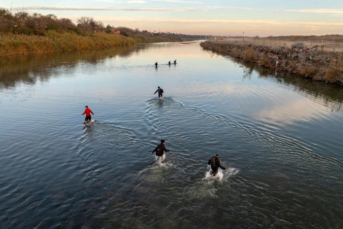 EAGLE PASS, TEXAS - JANUARY 07: In an aerial view, immigrants wade across the Rio Grande while crossing from Mexico into the United States on January 07, 2024 in Eagle Pass, Texas. According the a new report released by U.S. Department of Homeland Security, some 2.3 million migrants, mostly from families seeking asylum, have been released into the U.S. under the Biden Administration since 2021. (Photo by John Moore/Getty Images)