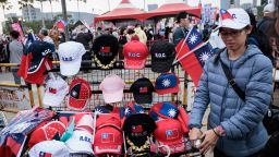 A street vender sells Taiwan flags and caps at a campaign rally of the main opposition Kuomintang (KMT) in Kaohsiung on January 7, 2024, a week before the presidential election.