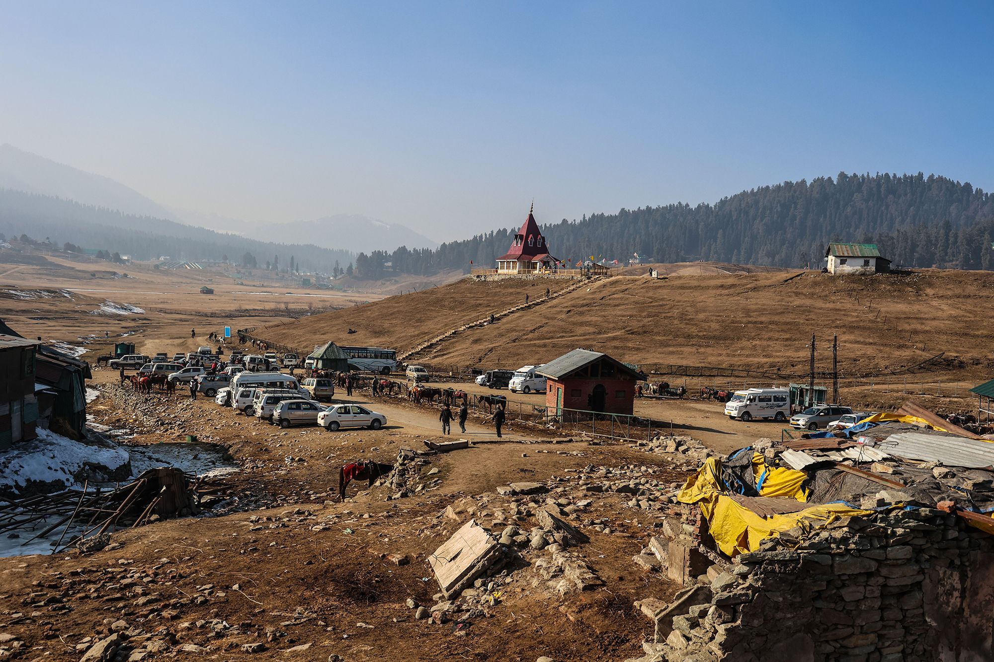 Mandatory Credit: Photo by Nasir Kachroo/NurPhoto/Shutterstock (14294301e)Tourists are enjoying themselves as a large number of commercial and private vehicles are parked at the famous ski resort of Gulmarg on a sunny winter day in Baramulla District, Jammu and Kashmir, India, on January 10, 2024. The Kashmir Valley is experiencing an unprecedented change in weather this winter. In January, tourist resorts such as Gulmarg, Sonmarg, and Pahalgam would typically be covered with ample snow by now. However, this year, the winter at the famous ski resort of Kashmir, Gulmarg, is dry with no snow. Tourists are saying that they mainly planned their Kashmir tour to witness snowfall and feel disappointed this year.Dry Weather In Kashmir, Gulmarg, India - 10 Jan 2024