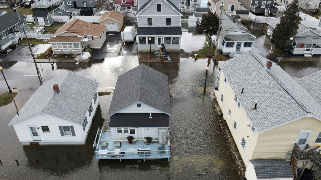 This aerial view shows homes are surrounded by flood waters in Hampton, New Hampshire, on January 10, 2024. Hampton police said they declared the emergency "as a result of extremely high seas and flooding." A storm packing high winds and heavy rain was sweeping through the Northeast early January 10. (Photo by Lauren Owens Lambert / AFP) (Photo by LAUREN OWENS LAMBERT/AFP via Getty Images)