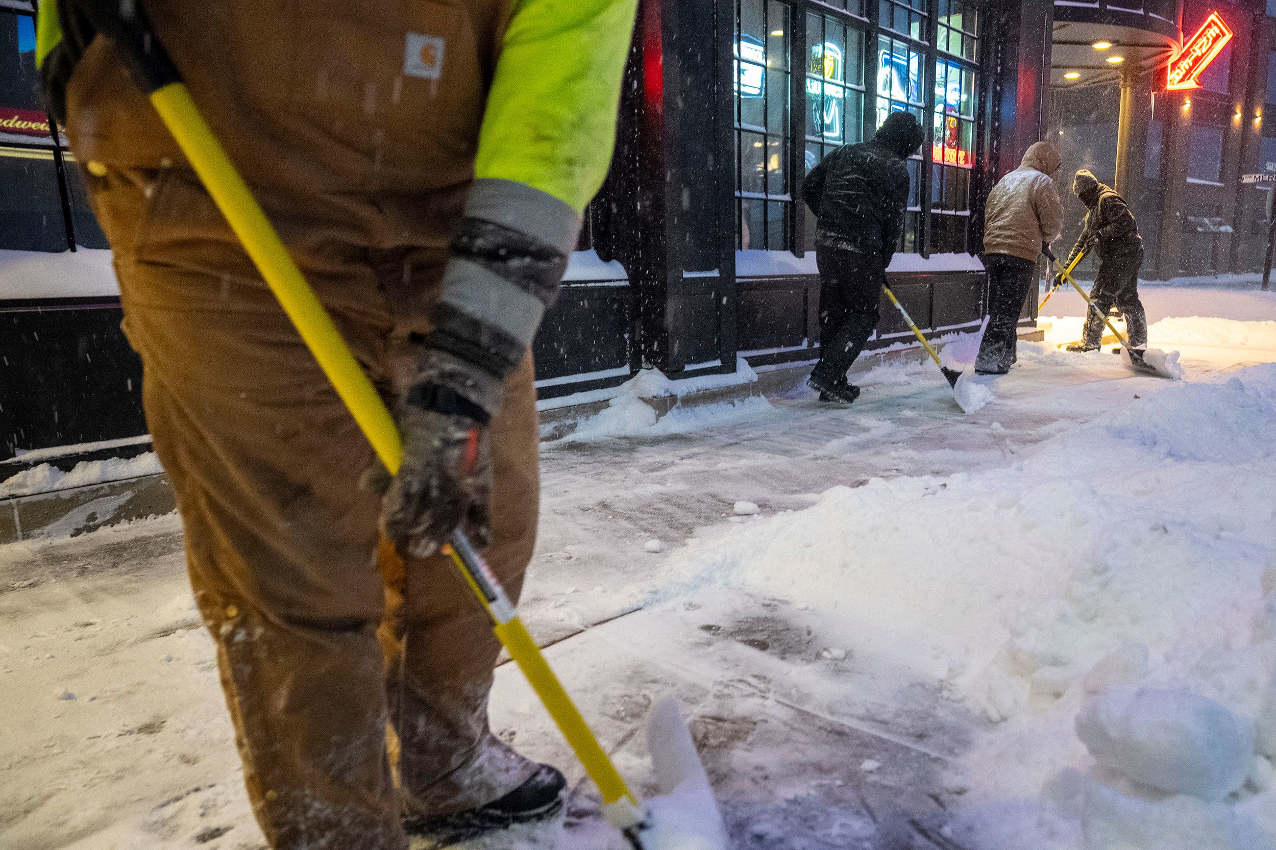 Workers shovel sidewalks in Ankeny, Iowa, on Friday. The vast majority of Iowa was under a blizzard warning Friday.