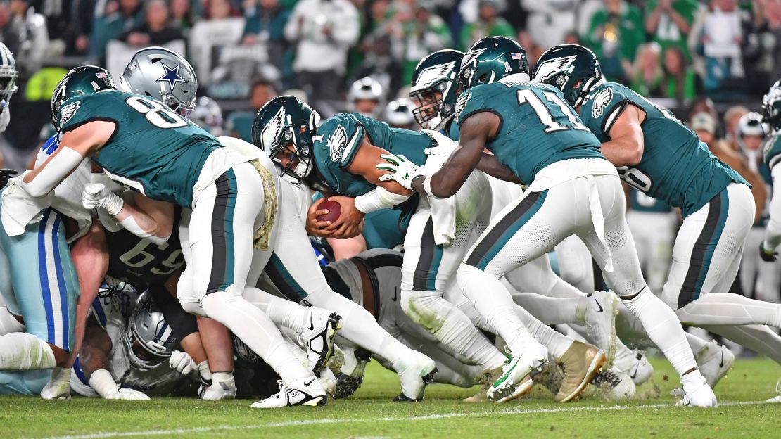 Nov 5, 2023; Philadelphia, Pennsylvania, USA; Philadelphia Eagles quarterback Jalen Hurts (1) picks up yardage a first down with a push from wide receiver A.J. Brown (11) and tight end Dallas Goedert (88) against the Dallas Cowboys at Lincoln Financial Field. Mandatory Credit: Eric Hartline-USA TODAY Sports