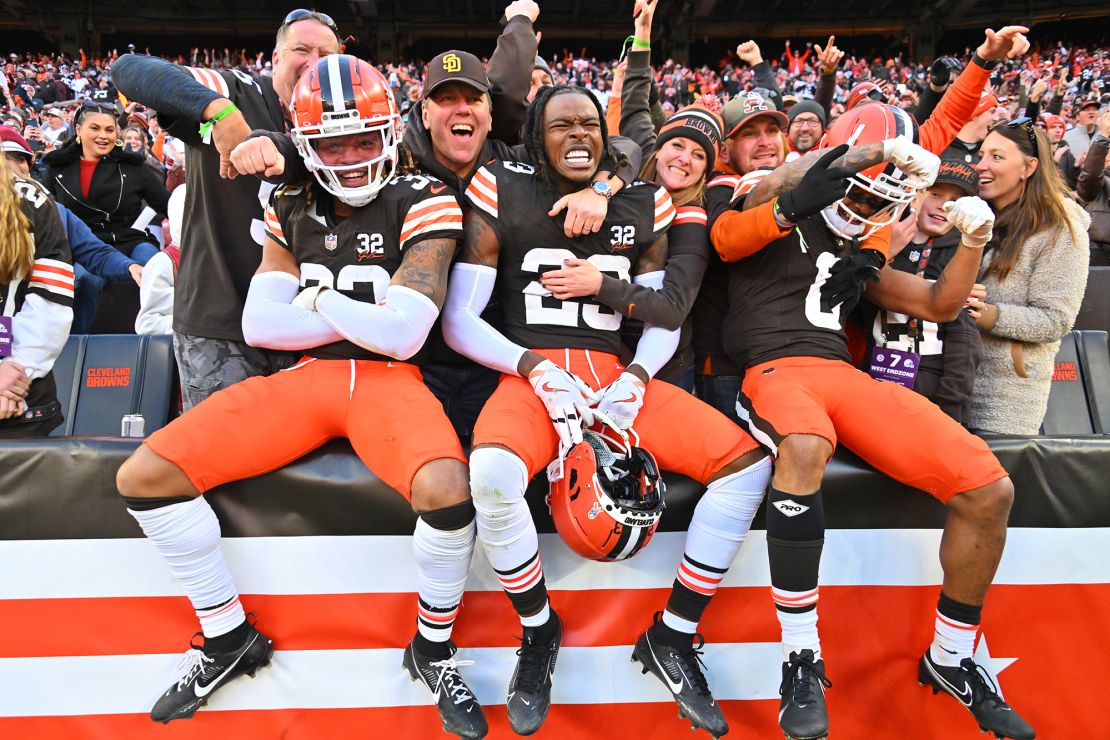 CLEVELAND, OHIO - NOVEMBER 19: Ronnie Hickman #33, Martin Emerson Jr. #23, and Greg Newsome II #0 of the Cleveland Browns celebrate with fans after beating the Pittsburgh Steelers 13-10 at Cleveland Browns Stadium on November 19, 2023 in Cleveland, Ohio. (Photo by Jason Miller/Getty Images)