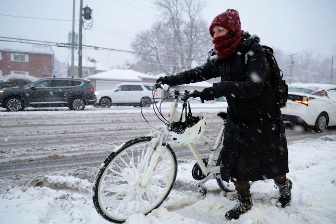 Rebecca Zimmerman walks beside her bicycle on her way to work in Oak Park, Illinois, on January 12.