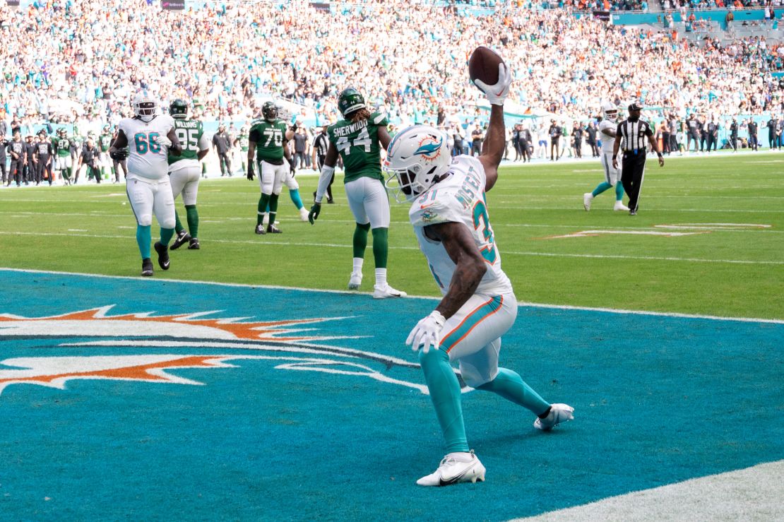Miami Dolphins running back Raheem Mostert (31) throws the ball on the field as he celebrates scoring a touchdown during an NFL football game against the New York Jets, Sunday, Dec 17, 2023, in Miami Gardens, Fla. (AP Photo/Doug Murray)