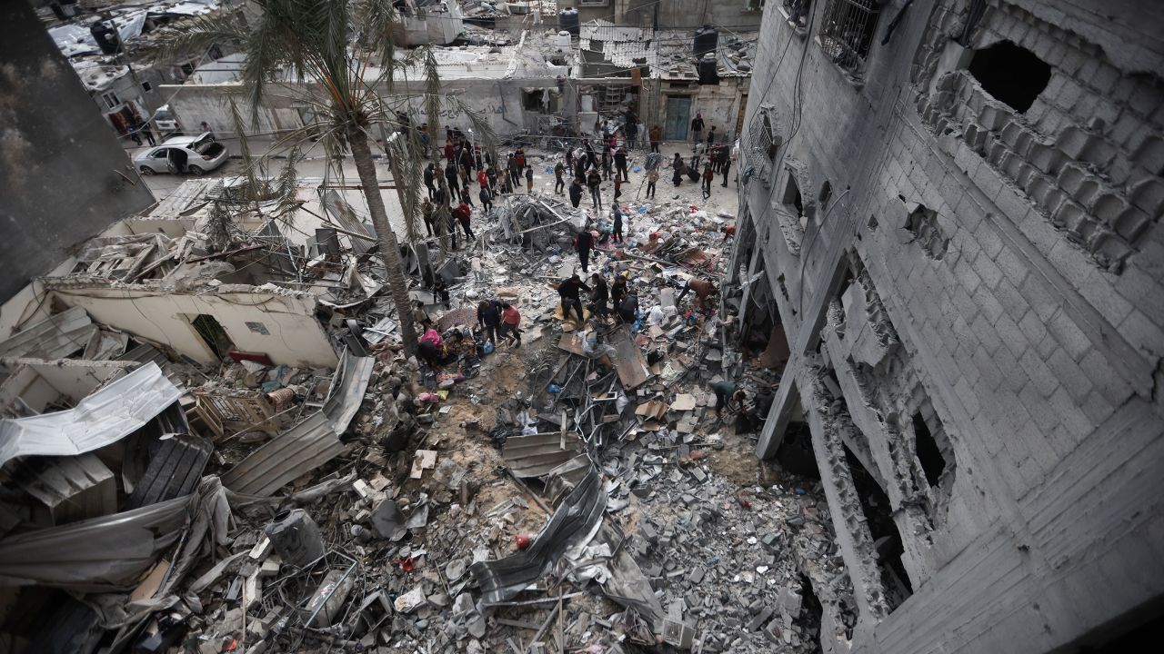 Palestinians look at the destruction after an Israeli strike in Kahan Younis, Gaza Strip, Friday, Jan. 12, 2024. AP Photo/Mohammed Dahman)