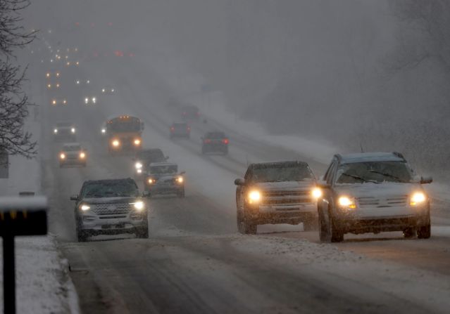 Vehicles slowly make their way along Northwestern Highway in Farmington Hills, Michigan, on January 12.