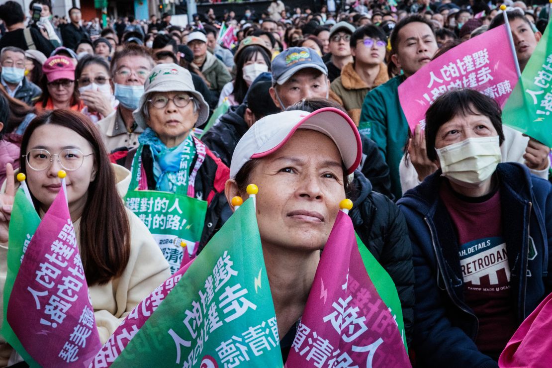 Supporters of the ruling Democratic Progressive Party (DPP) react as they look at an electronic screen showing the current vote tally for the presidential election in Taipei on January 13, 2024. Vote counting got under way on January 13 in Taiwan's presidential election, held in the shadow of threats from China that choosing the wrong leader could set the stage for war on the self-ruled island.