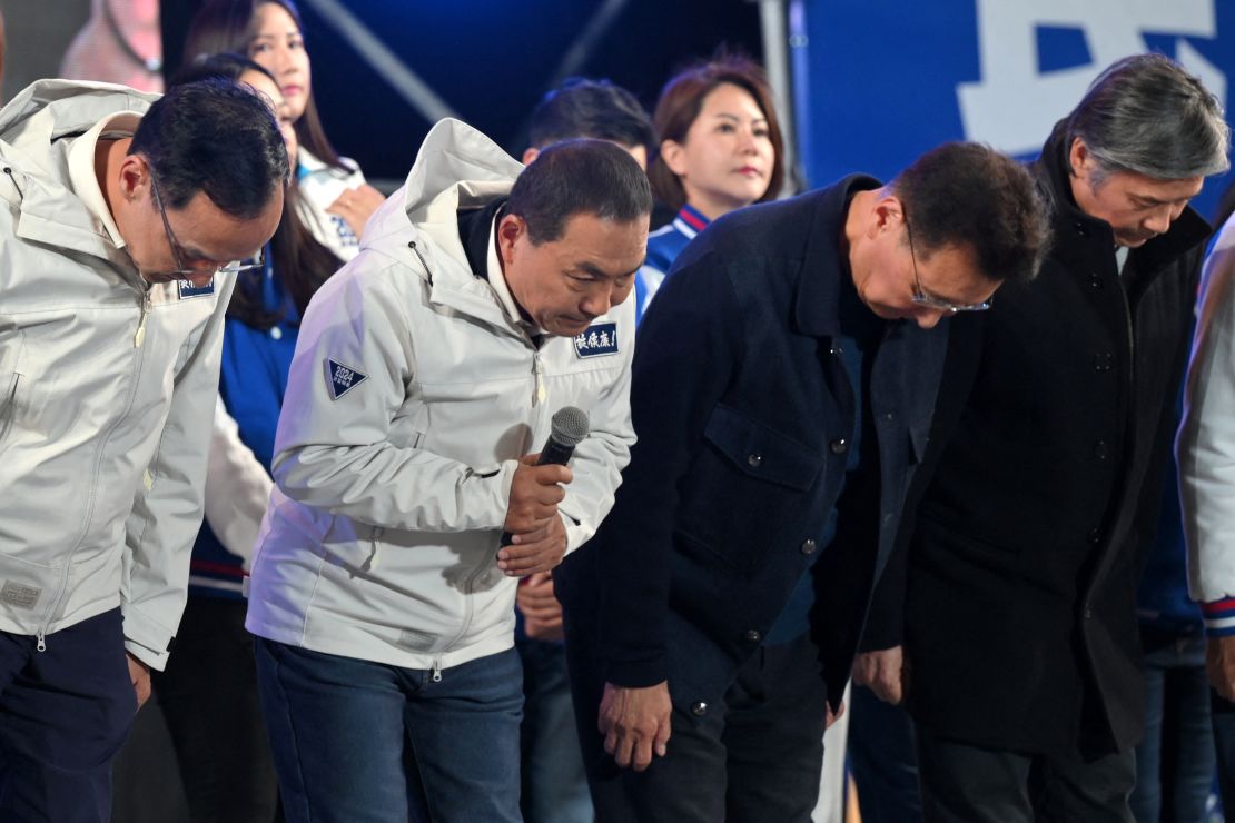 Taiwan's presidential candidate Hou Yu-ih of the main opposition Kuomintang (KMT) party (2nd L) bows beside his running mate Jaw Shaw-kong (2nd R) as they concede in the presidential election outside Banqiao stadium in New Taipei City on January 13, 2024. Taiwan's ruling party candidate Lai Ching-te, branded a threat to peace by China, was on course for victory in the island's presidential election on January 13, as his main rival conceded defeat.
