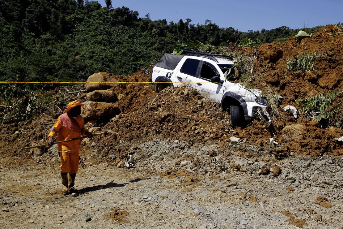 A member of the rescue team stands at the area of a landslide in the road between Quibdo and Medellin, Choco department, Colombia on January 13, 2024. At least 33 people died in a landslide on Friday in an indigenous community in northwest Colombia, according to an updated government report released this Saturday.