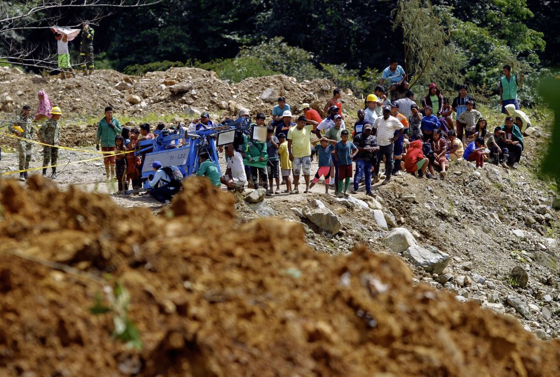 People observe the area where of a landslide in the road between Quibdo and Medellin, Choco department, Colombia on January 13, 2024. At least 33 people died in a landslide on Friday in an indigenous community in northwest Colombia, according to an updated government report released this Saturday.