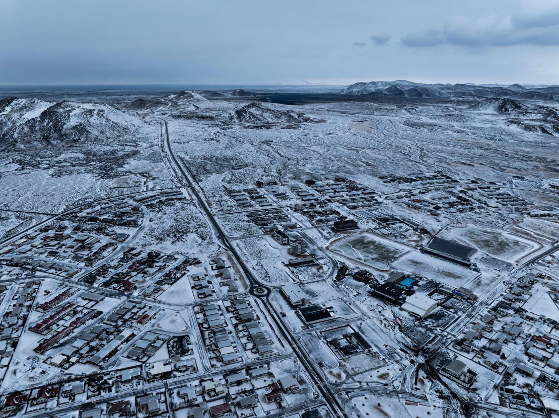 The lava field produced by volcanic activity can be seen in the top background above Grindavik on Iceland's Reykjanes Peninsula, Thursday, Dec. 21, 2023.