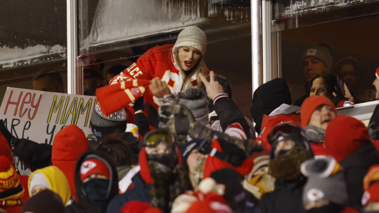 KANSAS CITY, MISSOURI - JANUARY 13: Taylor Swift celebrates with fans during the AFC Wild Card Playoffs between the Miami Dolphins and the Kansas City Chiefs at GEHA Field at Arrowhead Stadium on January 13, 2024 in Kansas City, Missouri. (Photo by David Eulitt/Getty Images)