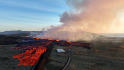 Aerial view taken on January 14, 2024 shows lava and smoke billowing over the landscape during a volcaninc eruption near the southwestern Icelandic town of Grindavik.