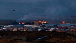 A stream of lava affects residential buildings in the southwestern Icelandic town of Grindavik after a volcanic eruption on January 14, 2024.