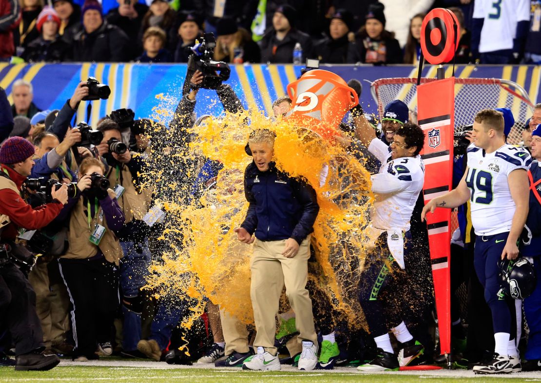 EAST RUTHERFORD, NJ - FEBRUARY 02: Tight end Zach Miller #86 and quarterback Russell Wilson #3 of the Seattle Seahawks dump Gatorade on head coach Pete Carroll in the fourth quarter of Super Bowl XLVIII against the Denver Broncos at MetLife Stadium on February 2, 2014 in East Rutherford, New Jersey. The Seattle Seahawks won 43-8. (Photo by Rob Carr/Getty Images)