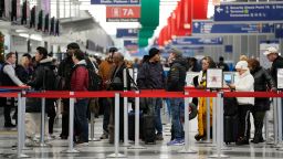 Travelers wait to go through security check point at the O'Hare International Airport in Chicago, Sunday, Jan. 14, 2024. Over 70 flight cancellations at Chicago airports Sunday. (AP Photo/Nam Y. Huh)