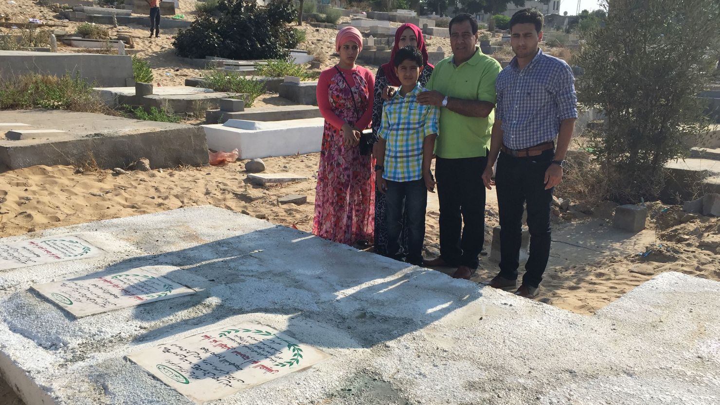 Dr. Izzeldin Abuelaish, with his children, visiting the graves of his daughters who were killed on January 16, 2009.