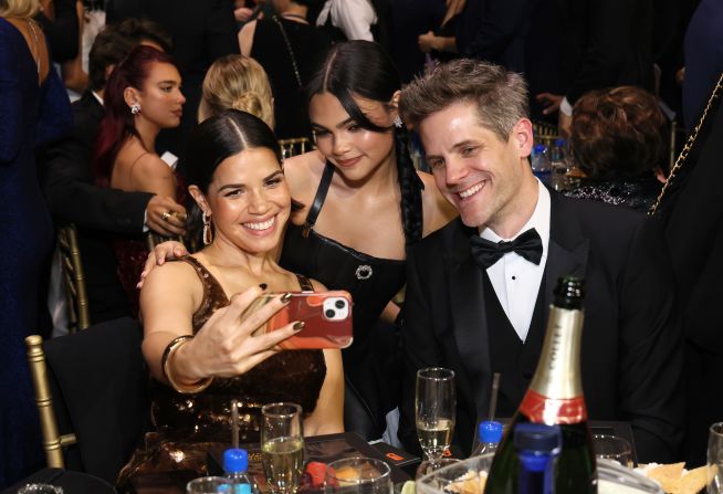 "Barbie" stars America Ferrera, Ariana Greenblatt and Ryan Piers Williams take a selfie in the crowd.