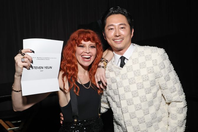 Presenter Natasha Lyonne holds up the envelope for Steven Yeun, winner of the best actor in a limited series or movie made for television award.