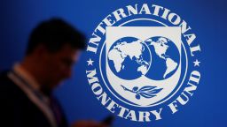 A participant stands near a logo of IMF at the International Monetary Fund - World Bank Annual Meeting 2018 in Nusa Dua, Bali, Indonesia, October 12, 2018. REUTERS/Johannes P. Christo