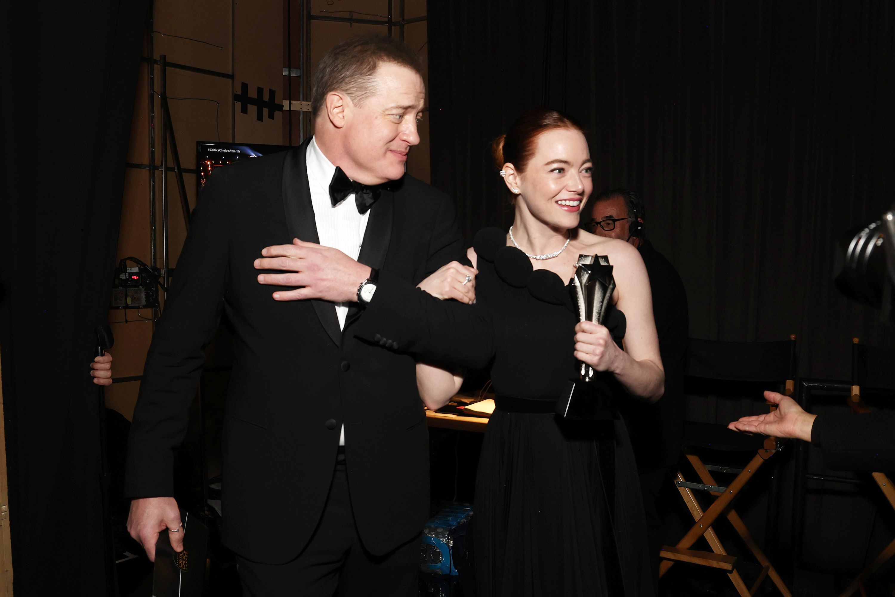 Brendan Fraser walks backstage with Emma Stone, winner of the best actress award for "Poor Things."