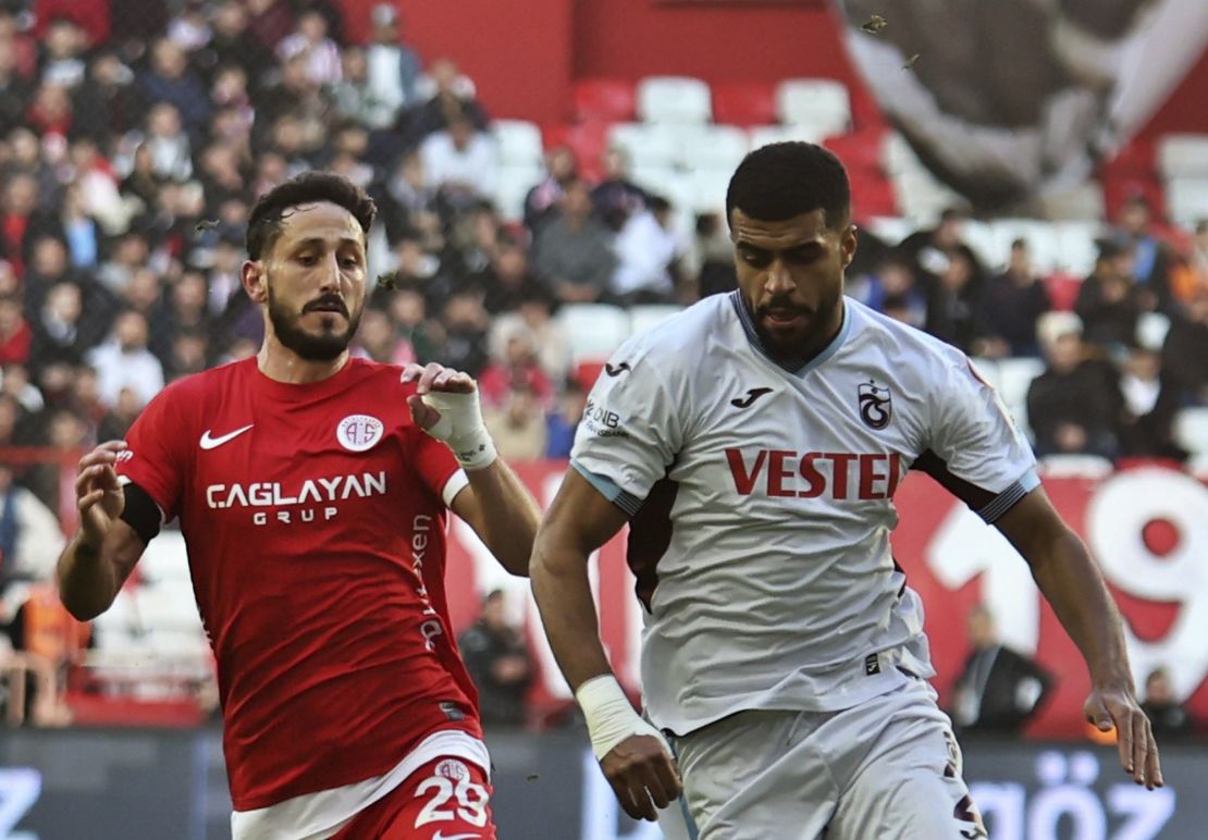 Antalyaspor's Sagiv Jehezkel, left, vies for the ball with Trabzonspor's Rayyan Baniya during a Turkish Super Lig soccer match between Antalyaspor and Trabzonspor in Antalya, southern Turkey, Sunday, Jan. 14, 2024. Turkish authorities have detained Turkish top-flight soccer club Antalyaspor's Israeli player Sagiv Jehezkel for questioning after he displayed solidarity with people held hostage by the Hamas militant organization during a league game. (Cafer Eser/IHA via AP)