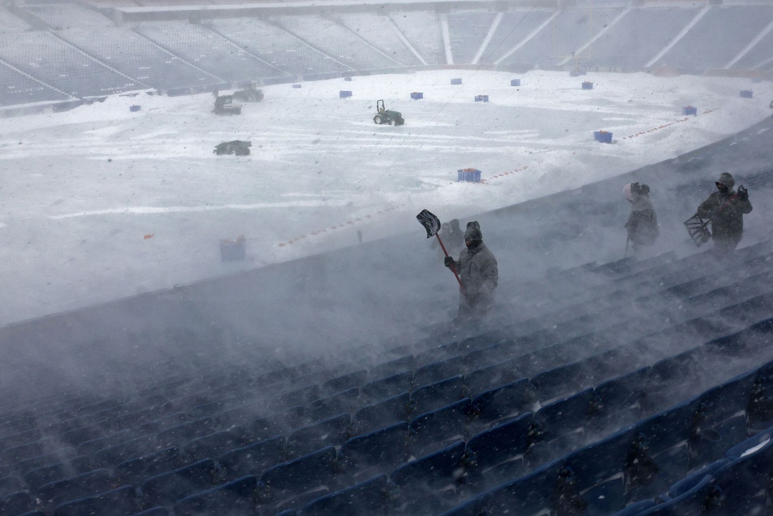 Workers remove snow from Highmark Stadium in Orchard Park, New York, on Sunday, January 14. The NFL playoff game between the Buffalo Bills and the Pittsburgh Steelers <a href="index.php?page=&url=https%3A%2F%2Fwww.cnn.com%2F2024%2F01%2F15%2Fsport%2Fnfl-wild-card-monday-bills-steelers-bucs-eagles-preview-spt-intl%2Findex.html" target="_blank">was pushed back a day </a>due to dangerous blizzard conditions.