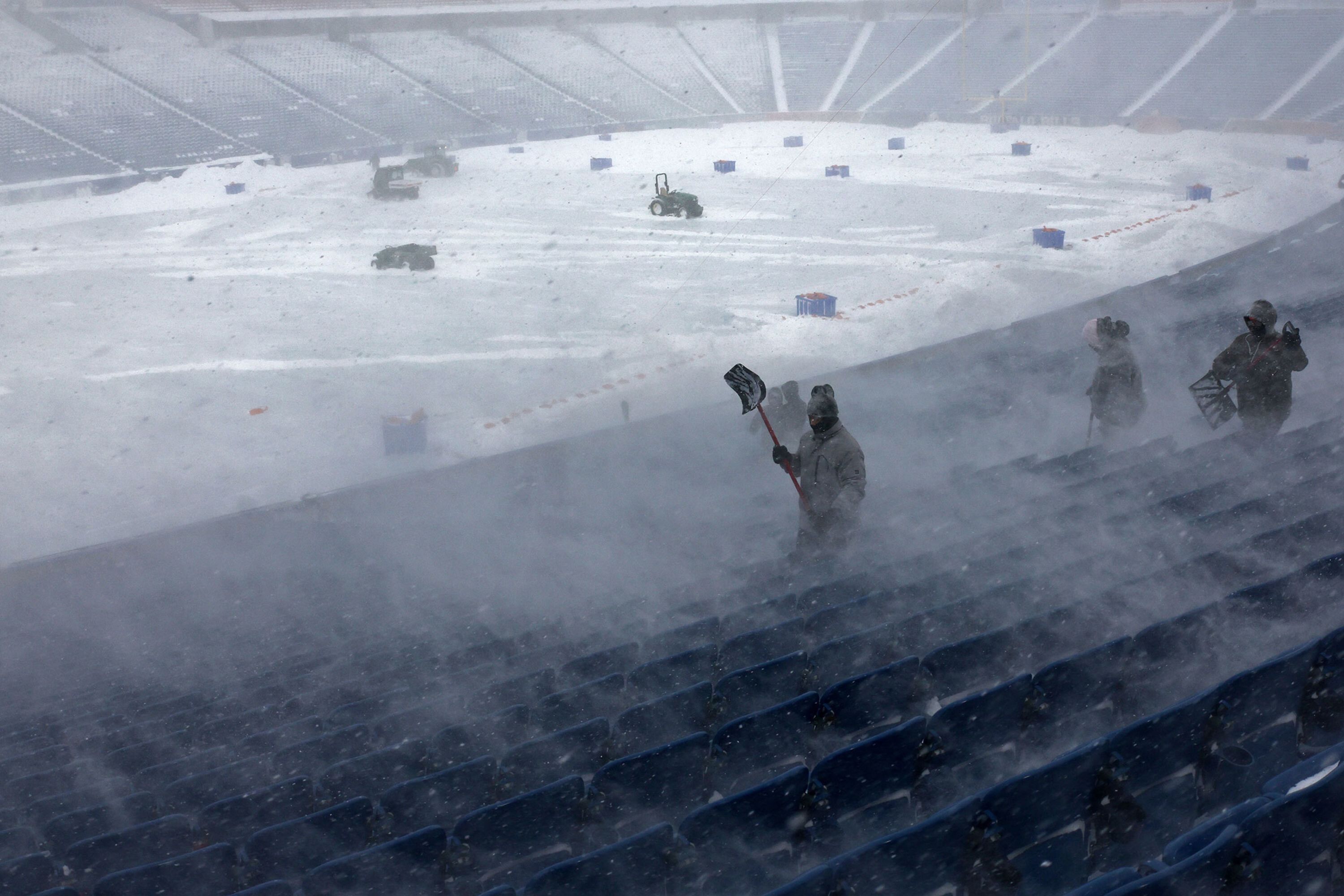 Workers remove snow from Highmark Stadium in Orchard Park, New York, on Sunday, January 14. An NFL game between the Buffalo Bills and the Pittsburgh Steelers <a href="https://www.cnn.com/2024/01/15/sport/nfl-wild-card-monday-bills-steelers-bucs-eagles-preview-spt-intl/index.html" target="_blank">was delayed</a> due to dangerous blizzard conditions. 