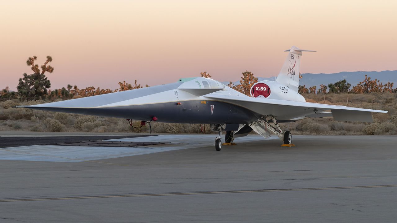 NASA's X-59 quiet supersonic research aircraft sits on the ramp at Lockheed Martin Skunk Works in Palmdale, California during sunrise, shortly after completion of painting. With its unique design, including a 38-foot-long nose, the X-59 was built to demonstrate the ability to fly supersonic, or faster than the speed of sound, while reducing the typically loud sonic boom produced by aircraft at such speeds to a quieter sonic "thump". The X-59 is the centerpiece of NASA's Quesst mission, which seeks to solve one of the major barriers to supersonic flight over land, currently banned in the United States, by making sonic booms quieter. 