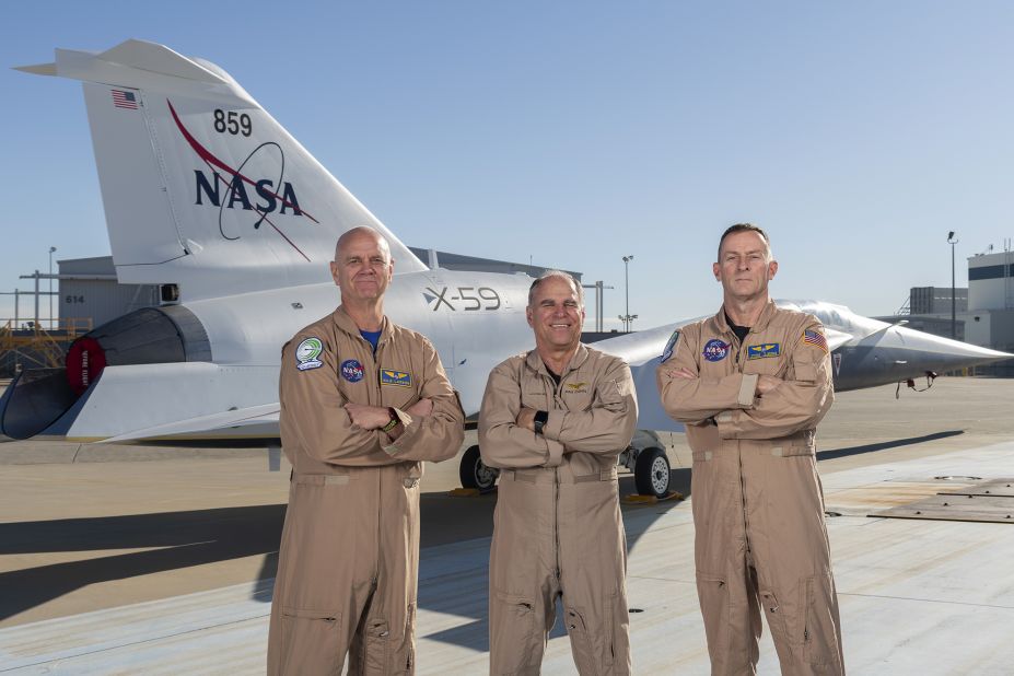 <strong>Test pilots:</strong> NASA pilots Nils Larson (left) and Jim "Clue" Less (right), and Lockheed Martin test pilot Dan "Dog" Canin pose with the newly painted X-59 as it sits on the ramp at Lockheed Martin Skunk Works in Palmdale, California. 