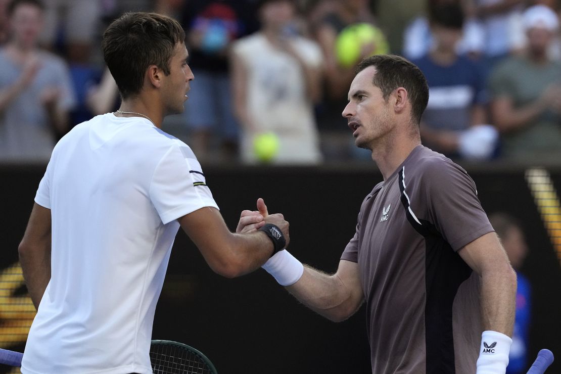 Tomas Martin Etcheverry, left, of Argentina is congratulated by Andy Murray of Britain following their first round match at the Australian Open tennis championships at Melbourne Park, Melbourne, Australia, Monday, Jan. 15, 2024. (AP Photo/Andy Wong)