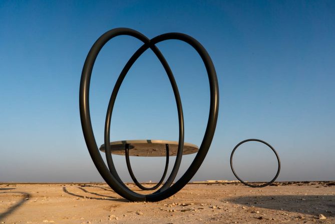 "From a distance, the mirrored undersides of the cluster of circular shelters and free-standing rings can be seen shimmering on the horizon," Eliasson says. "Up close, you see how the half-pipes are reflected in the mirrors and become full circles."