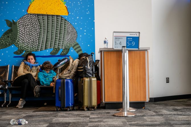 A family waits for their delayed flight at the Austin-Bergstrom International Airport in Austin, Texas, on January 15. Thousands of flights have been canceled or delayed.