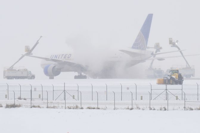 Crews work to de-ice an airplane at Denver International Airport on January 15.