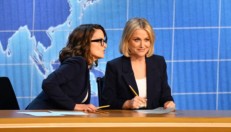Tina Fey, left, and Amy Poehler present an award in the style of the Weekend Update segment they used to host on "Saturday Night Live."