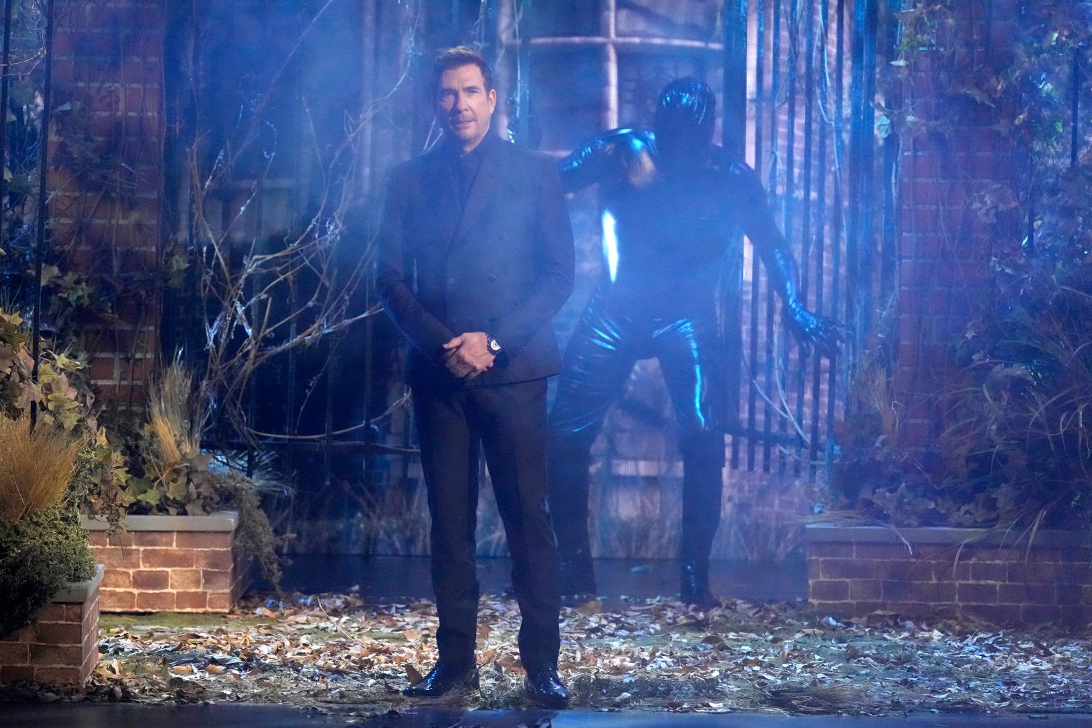 Dylan McDermott presents an award while host Anthony Anderson dresses up as a character from "American Horror Story."