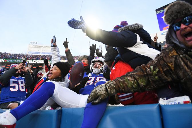 Buffalo Bills tight end Dawson Knox celebrates with fans after scoring a first-half touchdown against Pittsburgh on January 15. The Bills won 31-17.